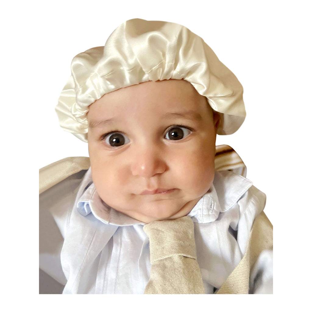 A baby wearing Silk baby mask for bald spots protection