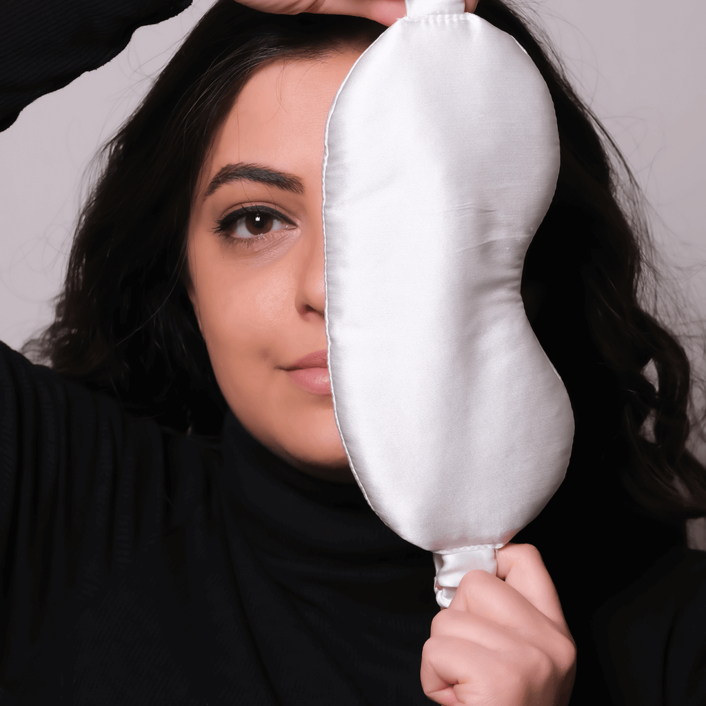 woman holding a silk eye sleeping mask