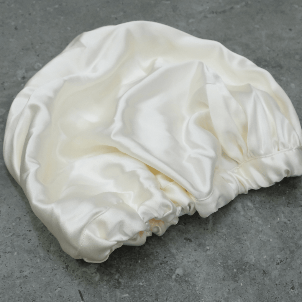Baby Silk hair Bonnet on a dark background used for hair & skin protection