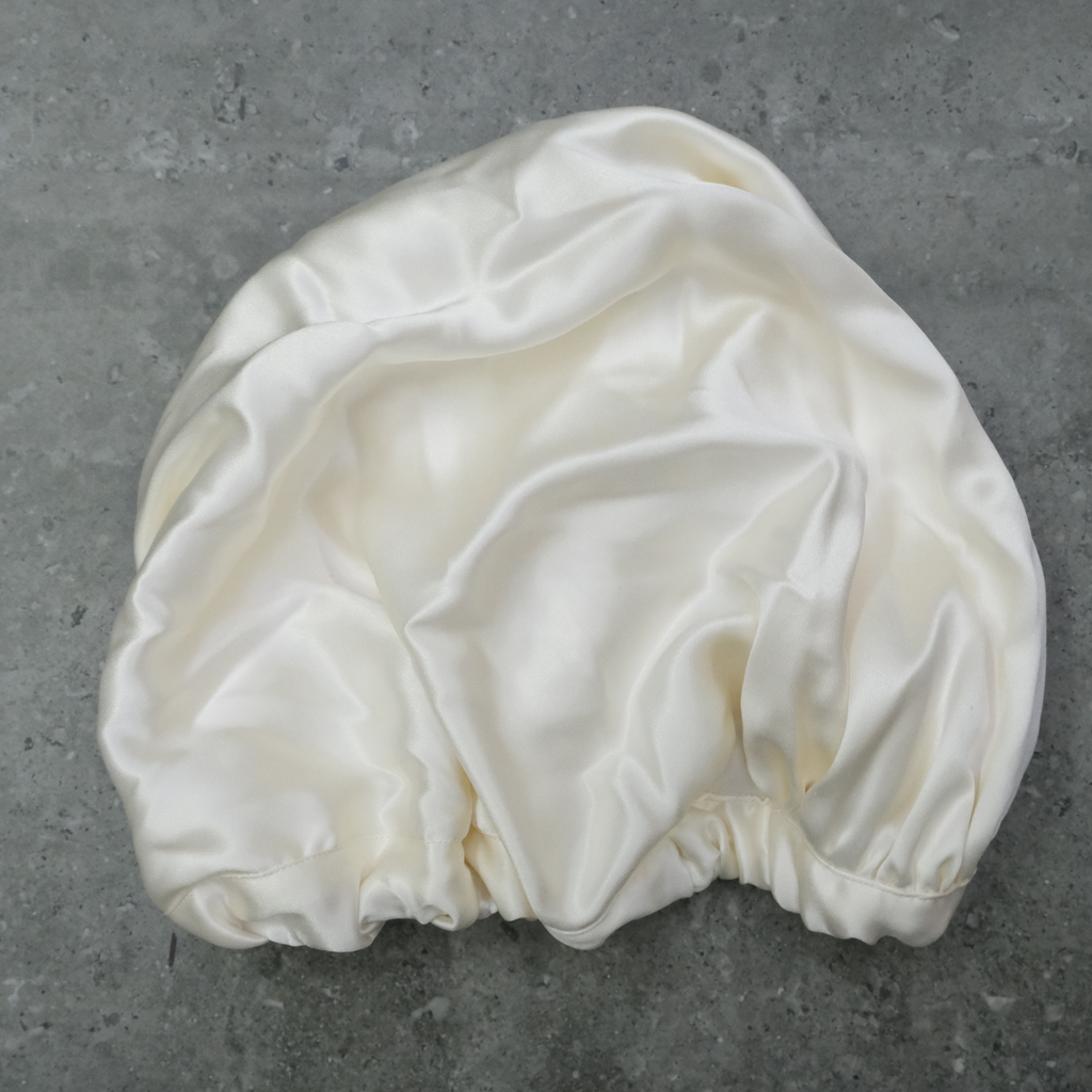 Baby Silk hair Bonnet on a dark background used for bald spot protection