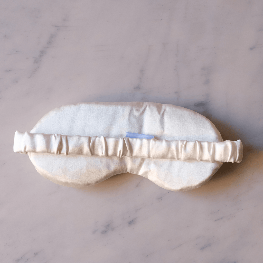 Back of silk eye sleeping mask on a white background